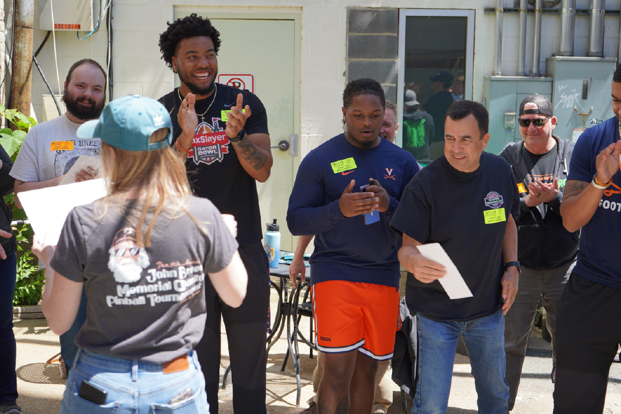 UVA Football players Tekai Kirby, John Rogers, Dakota Twitty, and Jalen McNair played pinball in support of the Ronald McDonald House of Charlottesville, connecting with local gamers at the John Breen Tournament at Decades Arcade.