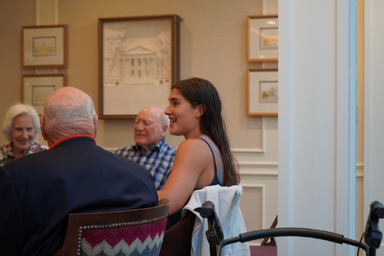The UVA Rowing team visited the Colonnades Retirement Community once a month. Pictured is Dylan Bentley, who has forged connections with the patrons over 2 years of visits.